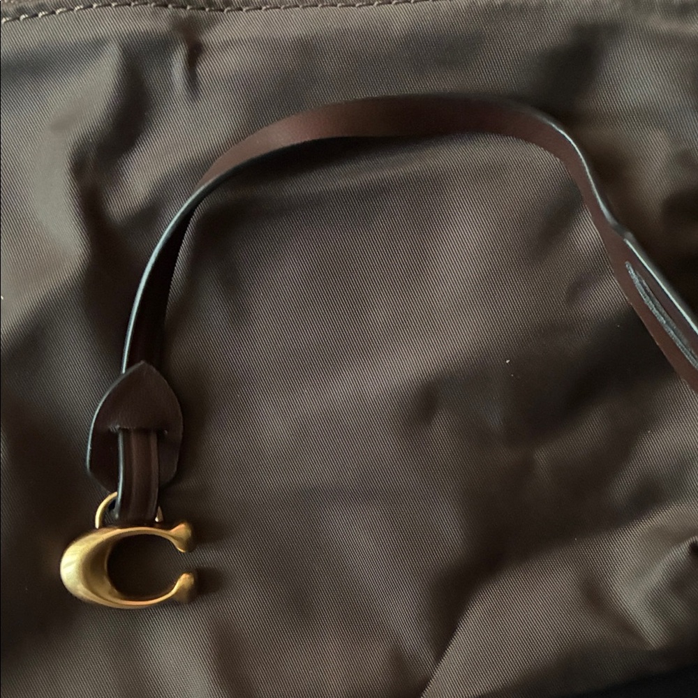 Coach C bagtag with brown leather strap